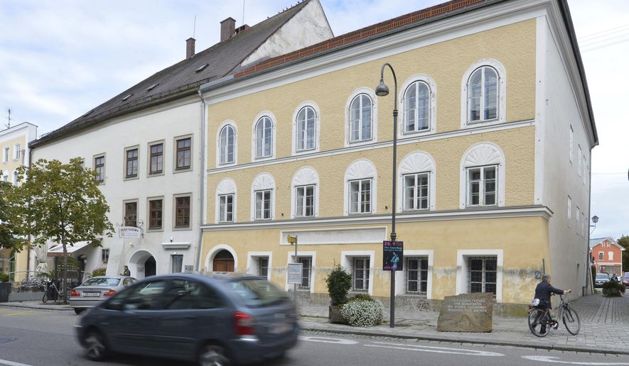 FILE - This Sept. 27, 2012 file picture shows an exterior view of Adolf Hitler's birth house , front, in Braunau am Inn, Austria. Austrian authorities say the house where Adolf Hitler was born in 1889 will become a police precinct, ending years of uncertainty over the building that's become a pilgrimage site for people who glorify the Nazi dictator. (AP Photo / Kerstin Joensson)