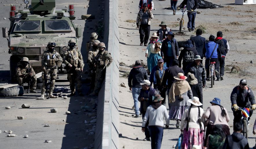 Soldiers guard the Senkata fuel plant in El Alto, on the outskirts of La Paz, Bolivia, Wednesday, Nov. 20, 2019. Security forces on Tuesday escorted gasoline tankers from the plant, that had been blockaded for five days by supporters of former President Evo Morales, and at least three people were reported killed while the operation was underway. (AP Photo/Natacha Pisarenko)