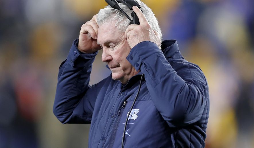 North Carolina coach Mack Brown adjusts his headset as he walks the sideline during the second half of the team's NCAA college football game against Pittsburgh, Thursday, Nov. 14, 2019, in Pittsburgh. Pittsburgh won 34-27 in overtime. (AP Photo/Keith Srakocic)
