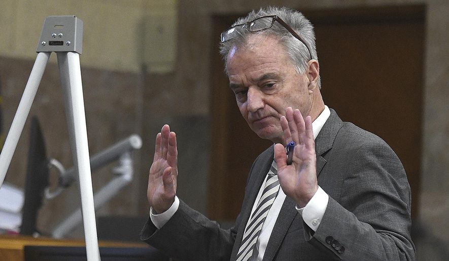 In this Monday, Nov. 18, 2019 photo Attorney John McGrory cross examines a witness on the stand at the Linn County Court House in Albany, Ore. Fourteen Oregon counties and 151 taxing districts have filed against the State of Oregon for breaching a decades-old contract concerning management of 700,000 acres of timberland. (Mark Ylen/Albany Democrat-Herald via AP)