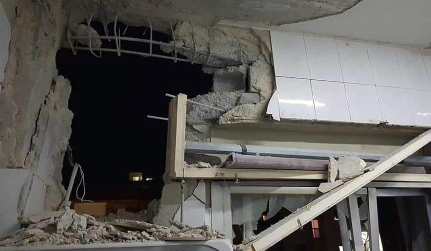 In this photo released by the Syrian official news agency SANA, a damaged building targeted by Israeli missile strikes is seen in Qudsaya suburb, western the capital Damascus, Syria, Wednesday, Nov. 20, 2019. The Israeli military on Wednesday said it struck dozens of Iranian targets in Syria, carrying out a &amp;quot;wide-scale&amp;quot; strike in response to rocket fire on the Israeli-controlled Golan Heights the day before. (SANA via AP)