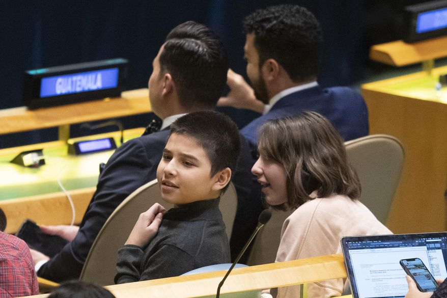 Young members of the Guatemalan delegation find UNICEF Goodwill Ambassador David Beckham in the audience during a high-level meeting on the occasion of the 30th anniversary of the adoption of the Convention on the Rights of the Child, Wednesday, Nov. 20, 2019 at United Nations headquarters. (AP Photo/Mary Altaffer)