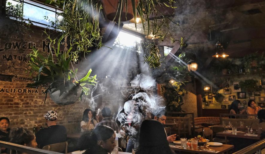 FILE - This Nov. 13, 2019 file photo shows patrons smoking marijuana at Lowell's Original Cannabis Cafe, a legal marijuana establishment, in Los Angeles. A divided House panel has endorsed a proposal to decriminalize and tax marijuana at the federal level. Groups supporting an end to the national prohibition on pot call the 24-10 vote by the House Judiciary Committee historic. However, even if passed in the House, the proposal faces an uncertain future in the Republican-controlled Senate. (AP Photo/Richard Vogel, File)
