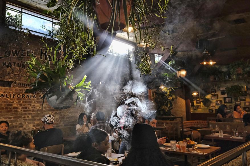FILE - This Nov. 13, 2019 file photo shows patrons smoking marijuana at Lowell's Original Cannabis Cafe, a legal marijuana establishment, in Los Angeles. A divided House panel has endorsed a proposal to decriminalize and tax marijuana at the federal level. Groups supporting an end to the national prohibition on pot call the 24-10 vote by the House Judiciary Committee historic. However, even if passed in the House, the proposal faces an uncertain future in the Republican-controlled Senate. (AP Photo/Richard Vogel, File)