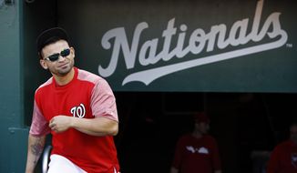 In this Oct. 18, 2019, file photo, Washington Nationals center fielder Gerardo Parra walks out of the clubhouse to participate in a baseball workout, in Washington.  The “Baby Shark” is moving to Japan. Outfielder Gerardo Parra has agreed to a contract with the Central League champion Yomiuri Giants, the team said Tuesday, Nov. 19, 2019. A two-time Gold Glove winner and a backup on this year’s World Series champion Washington Nationals, the 32-year-old outfielder became a fan favorite at Nationals Park this year for his “Baby Shark” walkup song, a tribute to the musical taste of his 2-year-old daughter Aaliyah. (AP Photo/Patrick Semansky, File)