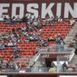  In this Oct. 6, 2019, file photo, fans watch play between the Washington Redskins and the New England Patriots during the second half of an NFL football game, in Landover, Md. There were more than 20,000 empty seats for the Redskins’ last home game, and when many of them have been filled this season, it’s with fans of the visiting team. It could be even emptier Sunday when the 1-9 Redskins host the 3-6-1 Detroit Lions. (AP Photo/Patrick Semansky, File)  **FILE**
