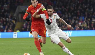 Zsolt Nagy, right, of Hungary and Gareth Bale of Wales in action during the Euro 2020 group E qualifying soccer match between Wales and Hungary at Cardiff City Stadium in Cardiff, Wales, Tuesday, Nov. 19, 2019. (Tamas Kovacs/MTI via AP)