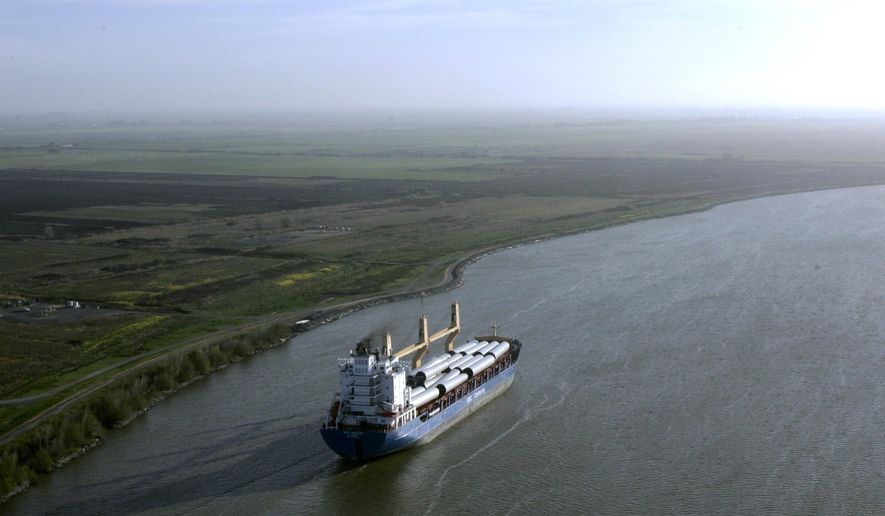 FILE - In this March 12, 2008 file photo, a ship sails through the Sacramento-San Joaquin River Delta near Bethel Island, Calif. California officials announced Thursday, Nov. 21, 2019 that they will sue the Trump administration to block its recently announced rules governing water in the San Joaquin Delta. (AP Photo/Rich Pedroncelli, File)