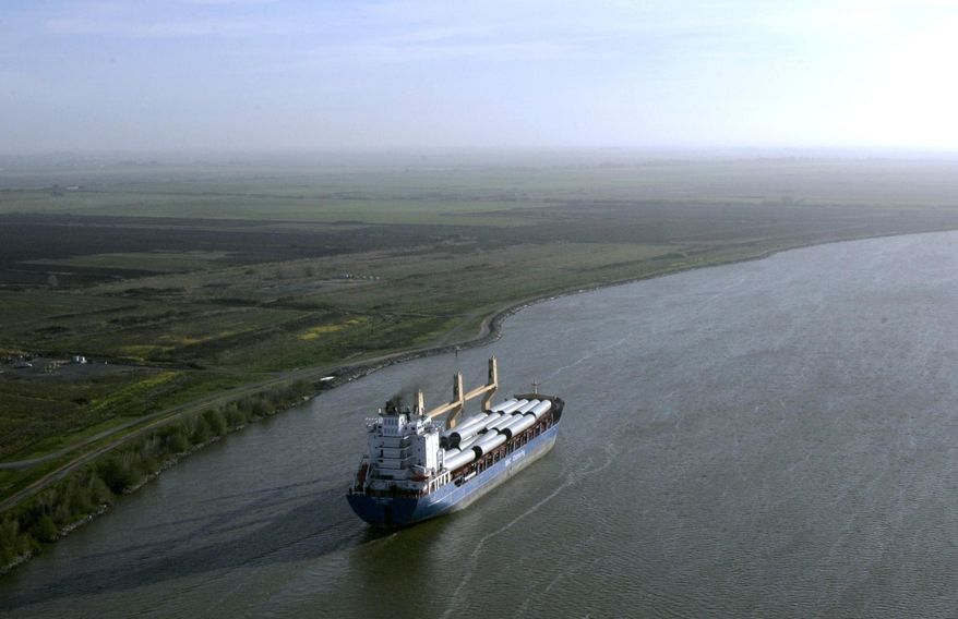 FILE - In this March 12, 2008 file photo, a ship sails through the Sacramento-San Joaquin River Delta near Bethel Island, Calif. California officials announced Thursday, Nov. 21, 2019 that they will sue the Trump administration to block its recently announced rules governing water in the San Joaquin Delta. (AP Photo/Rich Pedroncelli, File)