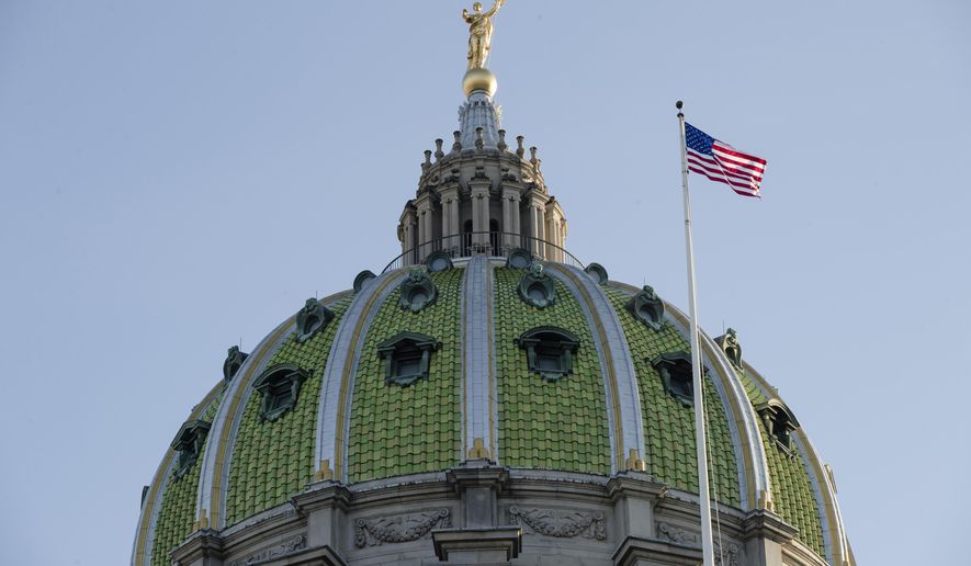 FILE- In this Jan. 15, 2019, file photo an America flag flies at the Pennsylvania Capitol building in Harrisburg, Pa. Pennsylvania lawmakers are expected to make the final vote on a bill to provide more time to file charges or lawsuits over cases of sexual abuse after a debate roiled by last year’s grand jury report into child molestation by Roman Catholic priests. A state House Republican spokesman says the chamber will vote Thursday, Nov. 21, 2019, likely sending it to Democratic Gov. Tom Wolf. (AP Photo/Matt Rourke, File)