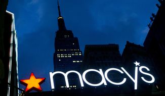 FILE - In this Nov. 21, 2013, file photo, with the Empire State building in the background, the Macy&#39;s logo is illuminated on the front of the department store in New York. Macy&#39;s Inc. (M) on Thursday, Nov. 21, 2019, reported fiscal third-quarter net income of $2 million. The Cincinnati-based company said it had net income of 1 cent per share. Earnings, adjusted for one-time gains and costs, came to 7 cents per share. (AP Photo/Mark Lennihan, File)