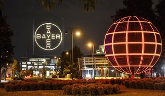 FILE -- This Aug. 9, 2019 file photo shows the Bayer logo at the main chemical plant of German Bayer AG in Leverkusen, Germany. Bayer subsidiary Monsanto has pleaded guilty to spraying a banned pesticide on research crops on the Hawaii island of Maui in 2014, prosecutors said. (AP Photo/Martin Meissner)