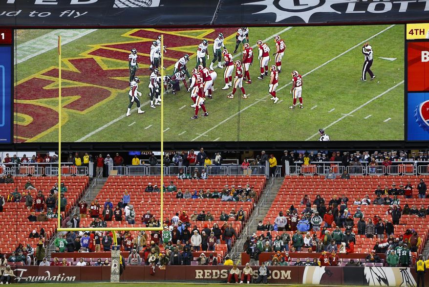 In this Nov. 17, 2019, file photo, some fans watch during the second half of an NFL football game between the Washington Redskins and the New York Jets, in Landover, Md. There were more than 20,000 empty seats for the Redskins’ last home game, and when many of them have been filled this season, it’s with fans of the visiting team. It could be even emptier Sunday when the 1-9 Redskins host the 3-6-1 Detroit Lions. (AP Photo/Patrick Semansky) ** FILE **