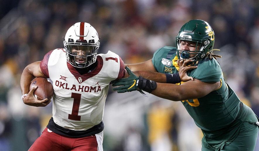 Oklahoma quarterback Jalen Hurts (1) stiff arms Baylor defensive tackle TJ Franklin (90) during an NCAA college football game, Saturday, Nov. 16, 2019, in Waco, Texas. Oklahoma won 34-31. (Ian Maule/Tulsa World via AP)