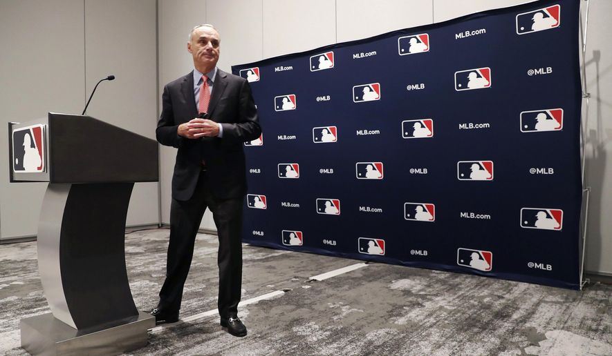 Baseball commissioner Rob Manfred steps away from the podium after speaking to the media at the owners meeting in Arlington, Texas, Thursday, Nov. 21, 2019. (AP Photo/LM Otero)