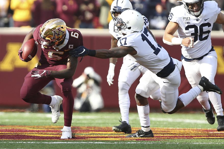 Minnesota wide receiver Tyler Johnson (6) escapes a tackle from Penn State safety Garrett Taylor (17) during an NCAA college football game, Saturday, Nov. 9, 2019, in Minneapolis. (AP Photo/Stacy Bengs)