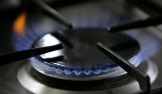 In this Jan. 11, 2006 file photo, a gas-lit flame burns on a natural gas stove in Stuttgart, Germany. A California restaurant organization is suing Berkeley over the city&#39;s ban on natural gas, which is set to take effect in January, 2020. The California Restaurant Association said in its lawsuit filed Thursday, Nov. 21, 2019, that many chefs use natural gas stoves and the prohibition will crimp the San Francisco Bay Area&#39;s reputation for international and fine cuisine. (AP Photo/Thomas Kienzle, File)