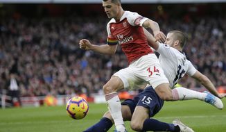 FILE - In this Sunday Dec. 2, 2018 file photo, Arsenal&#x27;s Granit Xhaka, left, fights for the ball with Tottenham&#x27;s Eric Dier during their English Premier League soccer match at the Emirates Stadium in London. Arsenal manager Unai Emery says Granit Xhaka might play against Southampton on Saturday, Nov. 23, 2019 after missing the last four games following his angry reaction to being jeered by the team’s own fans. Xhaka was stripped of the captaincy after swearing at heckling Arsenal supporters following his substitution in a 2-2 draw against Crystal Palace at Emirates Stadium. (AP Photo/Tim Ireland, file)