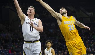 Notre Dame&#39;s Rex Pflueger (0) drives past Toledo&#39;s Dylan Alderson (21) during an NCAA college basketball game Thursday, Nov. 21, 2019, in South Bend, Ind. (Michael Caterina/South Bend Tribune via AP)