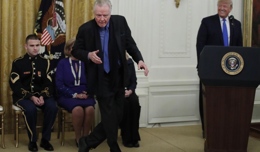 Jon Voight dances as President Donald Trump looks on during a National Medal of Arts and National Humanities Medal ceremony in the East Room of the White House, Thursday, Nov. 21, 2019, in Washington. (AP Photo/Alex Brandon)