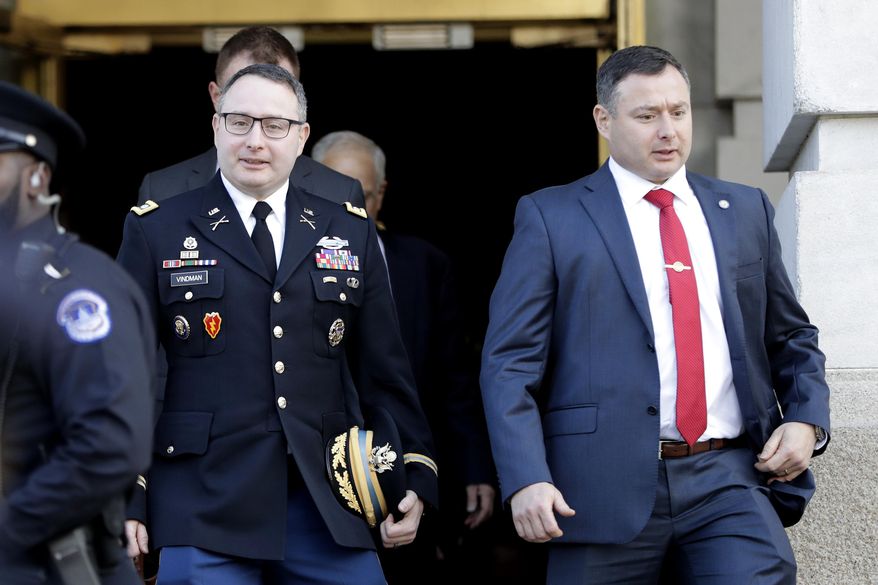 National Security Council aide Lt. Col. Alexander Vindman, left, walks with his twin brother, Army Lt. Col. Yevgeny Vindman, after testifying before the House Intelligence Committee on Capitol Hill in Washington, Tuesday, Nov. 19, 2019, during a public impeachment hearing of President Donald Trump&#x27;s efforts to tie U.S. aid for Ukraine to investigations of his political opponents. (AP Photo/Julio Cortez) ** FILE **