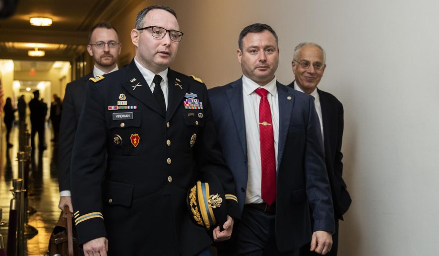 National Security Council aide Lt. Col. Alexander Vindman, left, leaves Capitol Hill as they conclude a public impeachment hearing of President Donald Trump&#39;s efforts to tie U.S. aid for Ukraine to investigations of his political opponents, in Washington, Tuesday, Nov. 19, 2019. (AP Photo/Manuel Balce Ceneta)