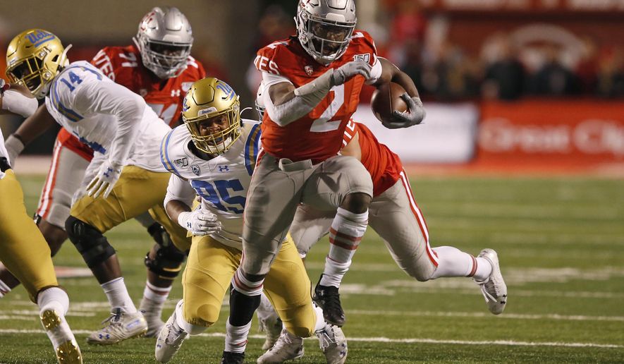 Utah running back Zack Moss (2) out runs UCLA linebacker Jason Harris (95) in the first half during an NCAA college football game Saturday, Nov. 16, 2019, in Salt Lake City. (AP Photo/Rick Bowmer)