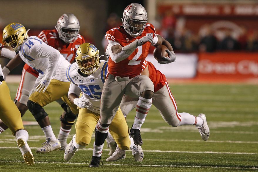 Utah running back Zack Moss (2) out runs UCLA linebacker Jason Harris (95) in the first half during an NCAA college football game Saturday, Nov. 16, 2019, in Salt Lake City. (AP Photo/Rick Bowmer)