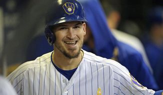 FILE - In this Sept. 7, 2019, file photo, Milwaukee Brewers&#39; Yasmani Grandal smiles in the dugout after hitting a solo home run during the eighth inning of a baseball game against the Chicago Cubs, in Milwaukee. All-Star catcher Yasmani Grandal agreed to a $73 million, four-year contract with the Chicago White Sox, finding a more lucrative free-agent market now that he no longer is burdened by draft-pick compensation. Grandal will earn $18.25 million annually as part of the deal announced Thursday, Nov. 21, 2019. (AP Photo/Aaron Gash, File)