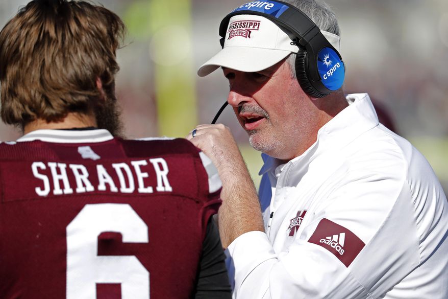 Mississippi State head coach Joe Moorhead, right, confers with quarterback Garrett Shrader (6) during the second half of an NCAA college football game against Alabama in Starkville, Miss., Saturday, Nov. 16, 2019. Alabama won 38-7. (AP Photo/Rogelio V. Solis)