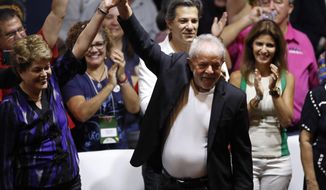 Former Brazilian President Luiz Inacio Lula da Silva, center, and former Brazilian president Dilma Rousseff raise their arms during the Workers&#39; Party 7th Congress, in Sao Paulo, Brazil, Friday, Nov. 22, 2019. Da Silva is the unquestioned star of the PT 3-day party convention. Many still think he could be the party&#39;s standard-bearer once again in 2022 - when he&#39;ll be a 77-year-old cancer survivor who is now barred from seeking office due to a corruption conviction. (AP Photo/Nelson Antoine)