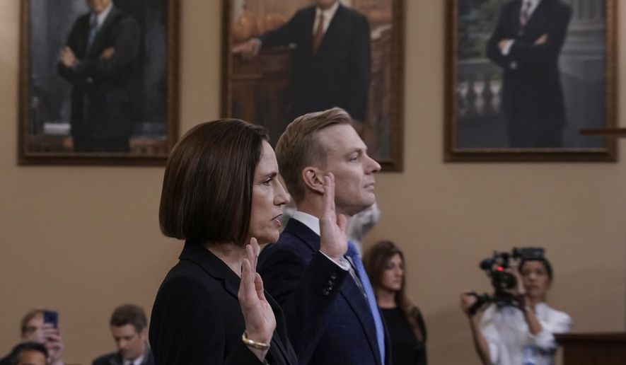 Former White House national security aide Fiona Hill, left, and David Holmes, a U.S. diplomat in Ukraine, are sworn in to testify before the House Intelligence Committee on Capitol Hill in Washington, Thursday, Nov. 21, 2019, during a public impeachment hearing of President Donald Trump's efforts to tie U.S. aid for Ukraine to investigations of his political opponents. (AP Photo/J. Scott Applewhite)