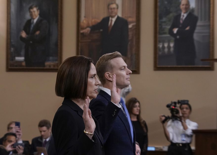 Former White House national security aide Fiona Hill, left, and David Holmes, a U.S. diplomat in Ukraine, are sworn in to testify before the House Intelligence Committee on Capitol Hill in Washington, Thursday, Nov. 21, 2019, during a public impeachment hearing of President Donald Trump's efforts to tie U.S. aid for Ukraine to investigations of his political opponents. (AP Photo/J. Scott Applewhite)