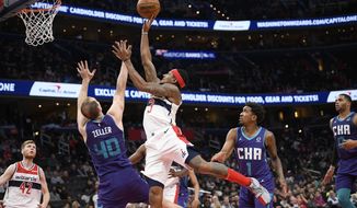 Washington Wizards guard Bradley Beal (3) goes to the basket as Charlotte Hornets forward Cody Zeller (40) and guard Malik Monk (1) defend during the second half of an NBA basketball game, Friday, Nov. 22, 2019, in Washington. Also seen is Wizards forward Davis Bertans (42). The Wizards won 125-118. (AP Photo/Nick Wass)