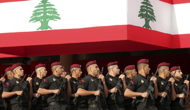 Lebanese marine special forces soldiers march during a military parade to mark the 76th anniversary of Lebanon&#x27;s independence from France at the Lebanese Defense Ministry, in Yarzeh near Beirut, Lebanon, Friday, Nov. 22, 2019. Lebanon&#x27;s top politicians attended Friday a military parade on the country&#x27;s 76th Independence Day, appearing for the first time since the government resigned amid nationwide protests now in their second month. (AP Photo/Hassan Ammar)