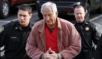 In this Oct. 29, 2015, file photo Former Penn State University assistant football coach Jerry Sandusky, center, arrives at the Centre County Courthouse for a hearing about his appeal on his child sex-abuse conviction, in Bellefonte, Pa. Sandusky is expected in a Pennsylvania courtroom Friday, Nov. 22, 2019, to be resentenced after an appeals court said mandatory minimum sentences had been improperly applied against him. (AP Photo/Gene J. Puskar, File)