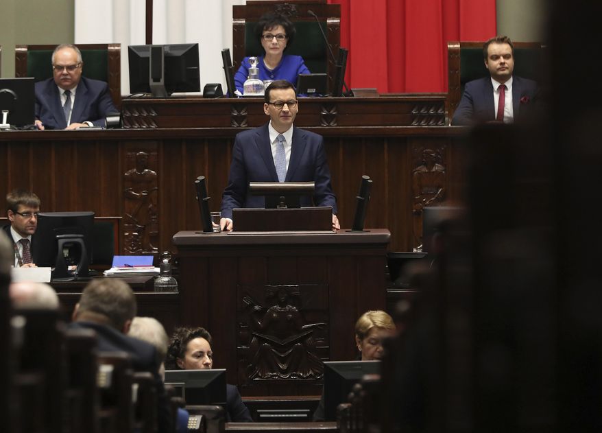 Poland's Prime Minister Mateusz Morawiecki vows to protect U.S. – EU ties and the crucial role of NATO, against criticism from some other European leaders, during his policy speech for his second term in office following October parliamentary elections, in Warsaw, Poland, Tuesday, Nov. 19, 2019. (AP Photo/Czarek Sokolowski)