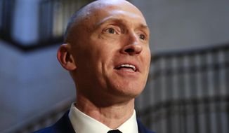 In this Nov. 2, 2017, photo, Carter Page, a foreign policy adviser to Donald Trump&#39;s 2016 presidential campaign, speaks with reporters following a day of questions from the House Intelligence Committee, on Capitol Hill in Washington. (AP Photo/J. Scott Applewhite) ** FILE **