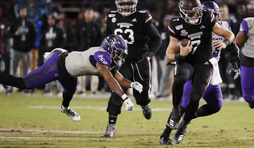 Mississippi State quarterback Tommy Stevens (7) evades an Abilene Christian defender as he runs for short yardage during the first half of an NCAA college football game, Saturday, Nov. 23, 2019, in Starkville, Miss. (AP Photo/Rogelio V. Solis)
