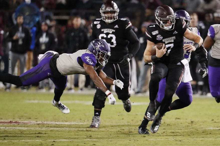 Mississippi State quarterback Tommy Stevens (7) evades an Abilene Christian defender as he runs for short yardage during the first half of an NCAA college football game, Saturday, Nov. 23, 2019, in Starkville, Miss. (AP Photo/Rogelio V. Solis)