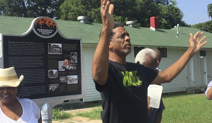 FILE - In this July 25, 2017 file photo, Rev. Willie Williams of Raleigh United Methodist Church in Sumner, Miss., prays during the rededication of the Emmett Till marker on the Mississippi Freedom Trail at Money, Miss. Memorials to Holocaust victims and others dedicated to people of color across the U.S. repeatedly are vandalized, forcing volunteers, cities and universities to spend hundreds of thousands on repairs and security. (Kathryn Eastburn/The Commonwealth via AP, File)