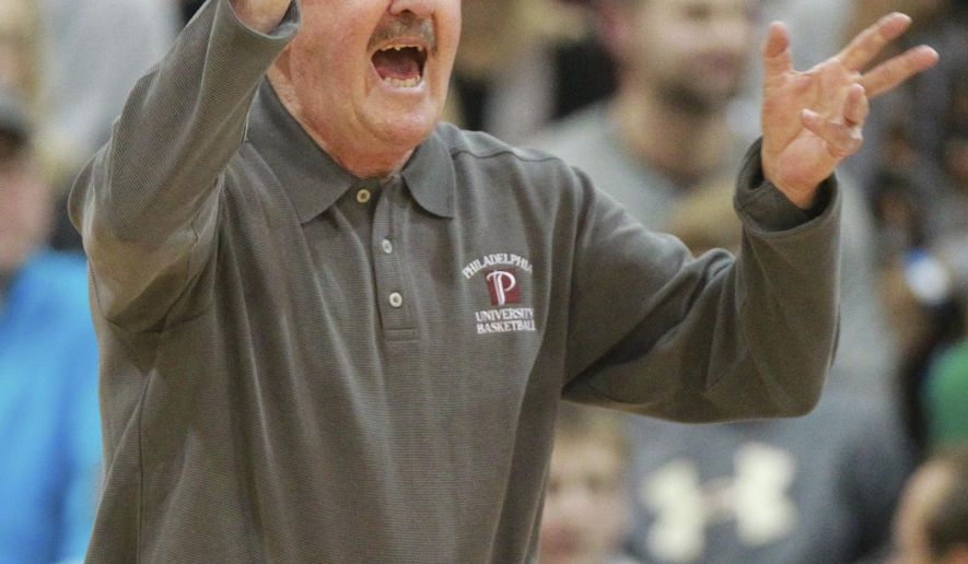 FILE - In this Feb. 3, 2015, file photo, Philadelphia University's Herb Magee gestures during the team's game against Wilmington in Philadelphia. Magee joined Duke coach Mike Krzyzewski as the only NCAA men's coaches to win 1,100 basketball games. Krzyzewski has 1,138 wins (1,065 with Duke) in a career that started with Army in 1975. Magee hit the magic number this week when Jefferson University (the new name for Philadelphia University) beat Kutztown 98-79 in front of maybe 1,000 fans at home on Henry Avenue. (Charles Fox/The Philadelphia Inquirer via AP, File)