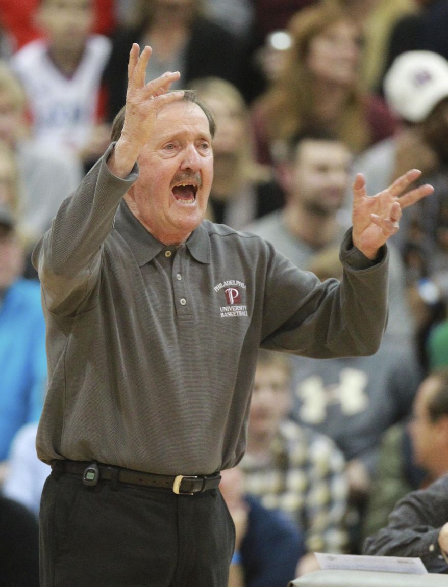 FILE - In this Feb. 3, 2015, file photo, Philadelphia University's Herb Magee gestures during the team's game against Wilmington in Philadelphia. Magee joined Duke coach Mike Krzyzewski as the only NCAA men's coaches to win 1,100 basketball games. Krzyzewski has 1,138 wins (1,065 with Duke) in a career that started with Army in 1975. Magee hit the magic number this week when Jefferson University (the new name for Philadelphia University) beat Kutztown 98-79 in front of maybe 1,000 fans at home on Henry Avenue. (Charles Fox/The Philadelphia Inquirer via AP, File)