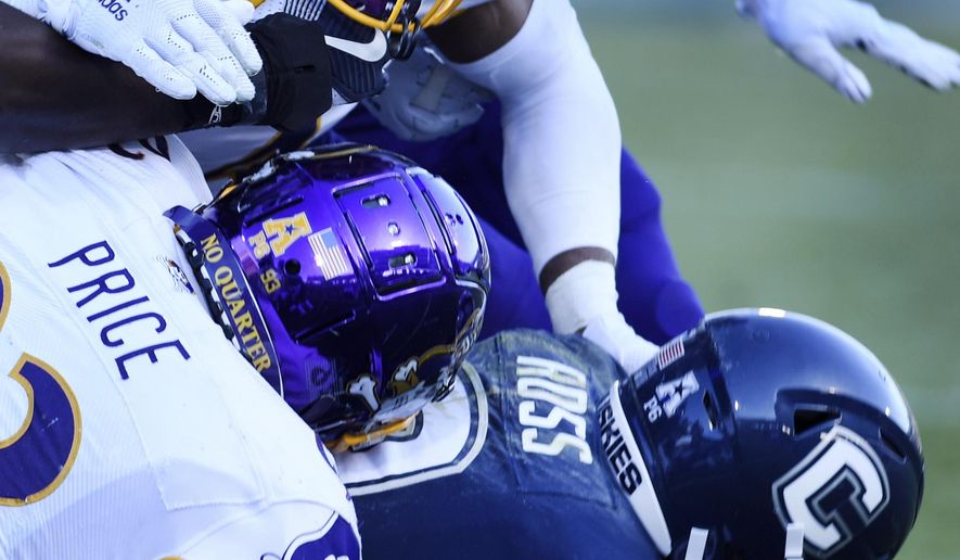 Connecticut wide receiver Cameron Ross (9) is taken down during the first half of an NCAA college football game against East Carolina, Saturday, Nov. 23, 2019, in East Hartford, Conn. (AP Photo/Stephen Dunn)