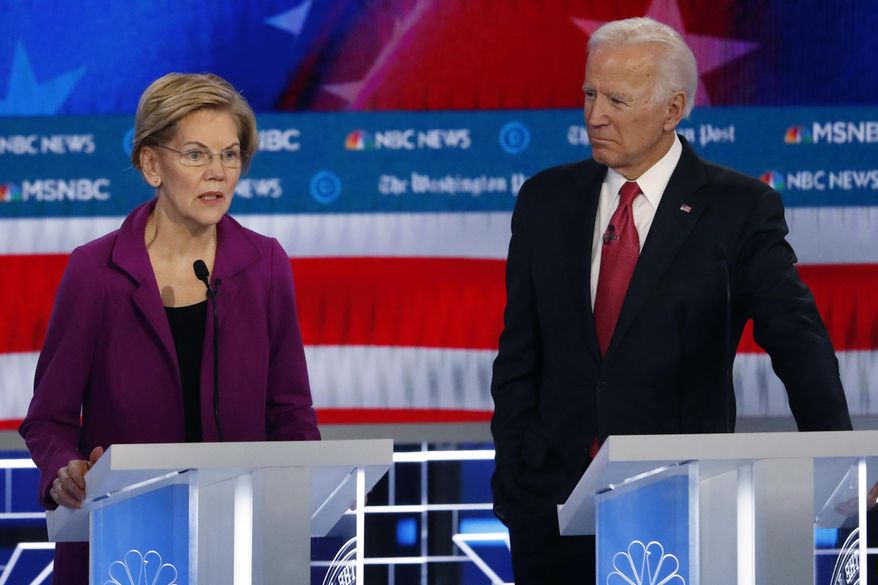 Democratic presidential candidate Sen. Elizabeth Warren, D-Mass., speaks as Democratic presidential candidate former Vice President Joe Biden listens during a Democratic presidential primary debate, Wednesday, Nov. 20, 2019, in Atlanta. (AP Photo/John Bazemore) ** FILE **