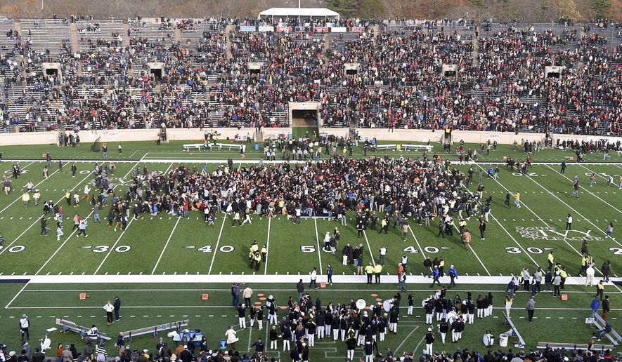 Demonstrators stage a climate change protest at the Yale Bowl delaying the start of the second half of an NCAA college football game between Harvard and Yale Saturday, Nov. 23, 2019, in in New Haven, Conn. (Arnold Gold/New Haven Register via AP)