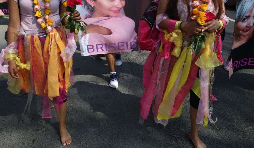 Women walk barefoot on asphalt, clothed in shreds of organza in pastel shades of pink and yellow, the favorite colors of murder victim Briseida Carreno, during a ceremony in her honor, in Ecatepec, a suburb of Mexico City, Saturday, Nov. 23, 2019. Mexico City’s mayor issued a gender alert this week for the capital, meaning that 20 of Mexico’s 31 federal entities have declared emergencies over the issue. Activists want more action, and are planning demonstrations to mark Monday’s International Day for the Elimination of Violence Women. (AP Photo/Alicia Fernandez)