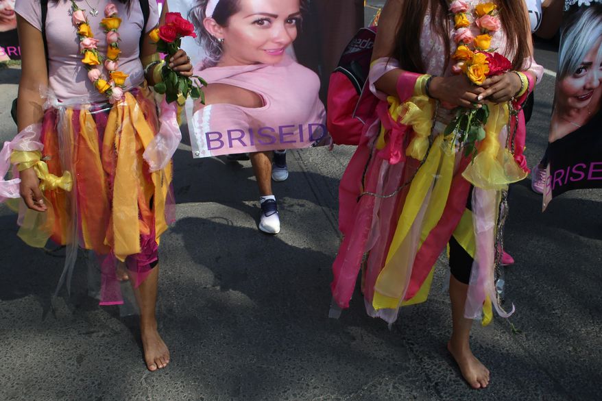 Women walk barefoot on asphalt, clothed in shreds of organza in pastel shades of pink and yellow, the favorite colors of murder victim Briseida Carreno, during a ceremony in her honor, in Ecatepec, a suburb of Mexico City, Saturday, Nov. 23, 2019. Mexico City’s mayor issued a gender alert this week for the capital, meaning that 20 of Mexico’s 31 federal entities have declared emergencies over the issue. Activists want more action, and are planning demonstrations to mark Monday’s International Day for the Elimination of Violence Women. (AP Photo/Alicia Fernandez)