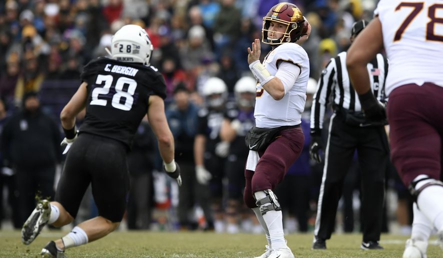 Minnesota quarterback Tanner Morgan (2) throws a pass against Northwestern linebacker Chris Bergin (27) during the first half of an NCAA football game Saturday, Nov. 23, 2019, in Evanston, Ill. (AP Photo/Paul Beaty)
