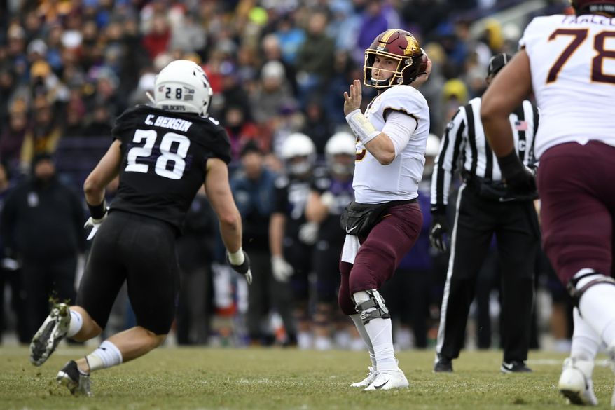 Minnesota quarterback Tanner Morgan (2) throws a pass against Northwestern linebacker Chris Bergin (27) during the first half of an NCAA football game Saturday, Nov. 23, 2019, in Evanston, Ill. (AP Photo/Paul Beaty)